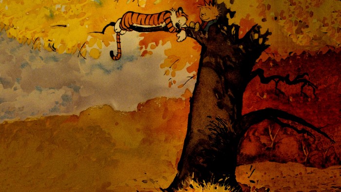 Calvin and Hobbes relaxing in a tree during fall