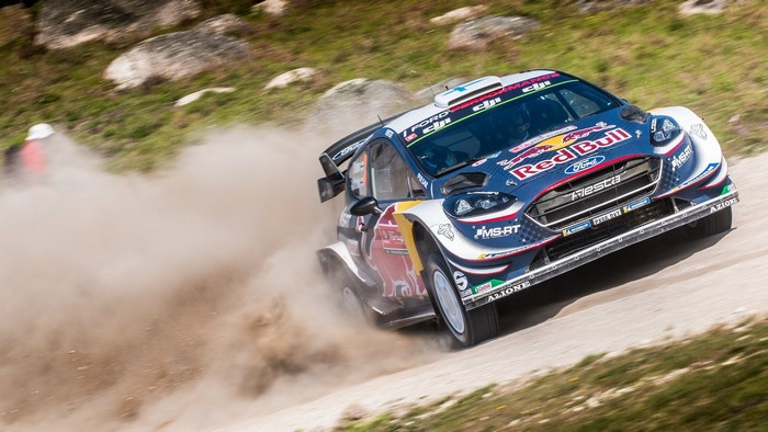 Teemu Suninen driving a Ford Fiesta rally car on a gravel road