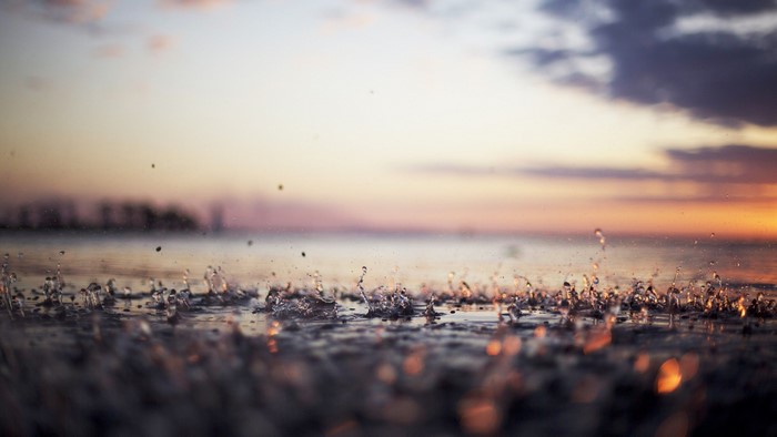 Sunset over water with rain drops