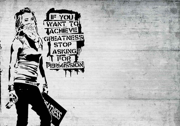 Graffiti of a woman with a message on a concrete wall