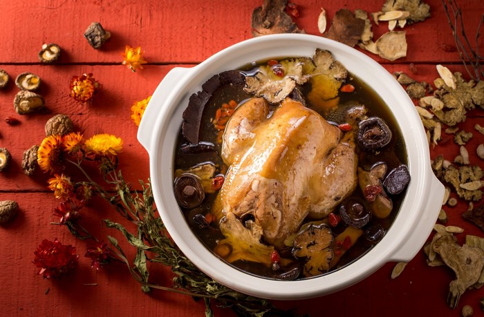 Whole chicken soup with mushrooms and herbs