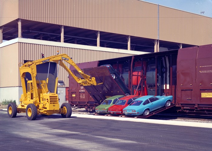 Yellow Cary-Lift loading cars onto a train