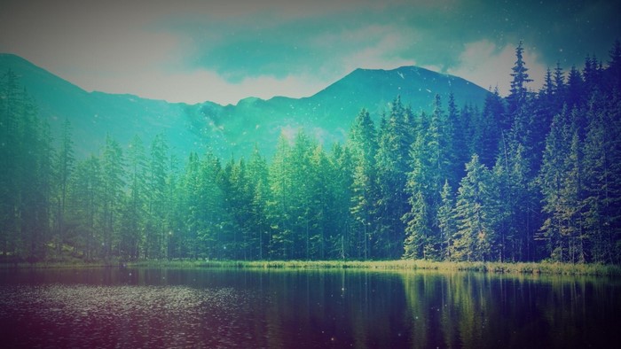 Lake and forest with mountains and cyan sky