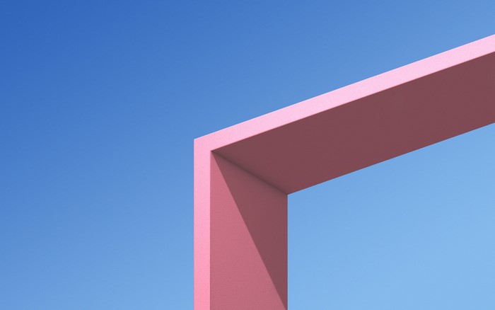 Pink architectural frame against a clear blue sky