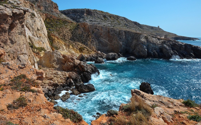Rocky coastline with blue ocean and clear sky
