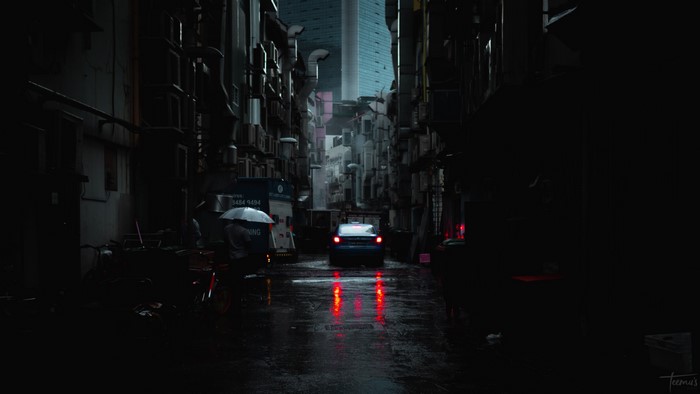 Dark Urban Street with Car and Umbrella
