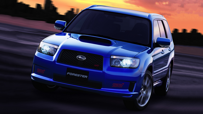 Blue Subaru Forester STI driving at sunset