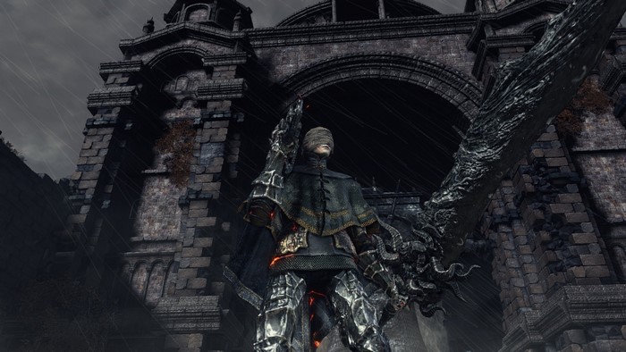 Dark Souls character with large sword in front of stone building