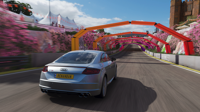 Audi TT RS driving through a colorful tunnel in Forza Horizon 4