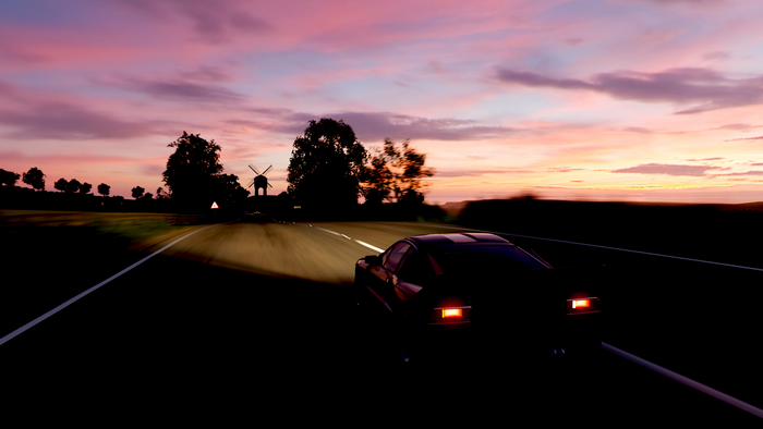 Car driving on road at sunset in Forza Horizon 4