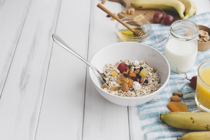 Healthy breakfast with oatmeal, fruits, milk, and juice