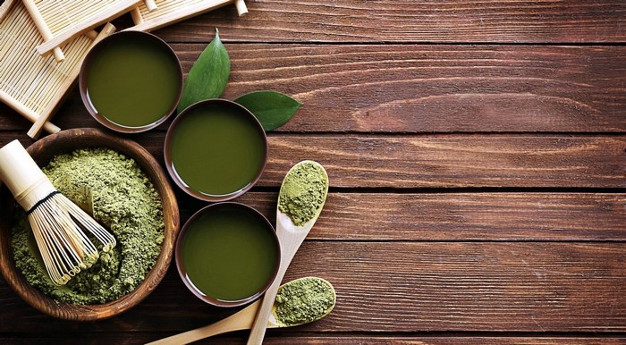 Matcha tea preparation on a wooden surface