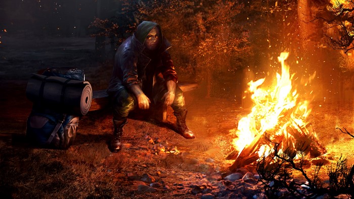 Man sitting by campfire in forest