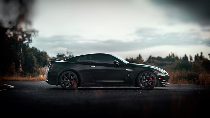 Black Nissan GT-R parked on asphalt road