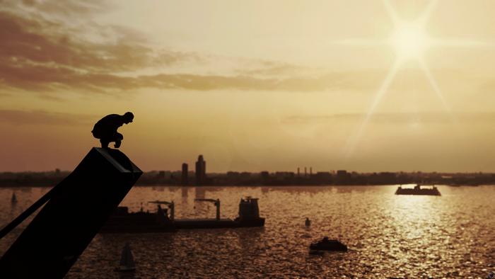 Silhouette of Spider-Man from Marvel's Spider-Man on a structure overlooking a river at sunset
