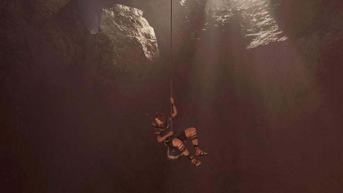 Lara Croft from Shadow of the Tomb Raider rappelling down a cave