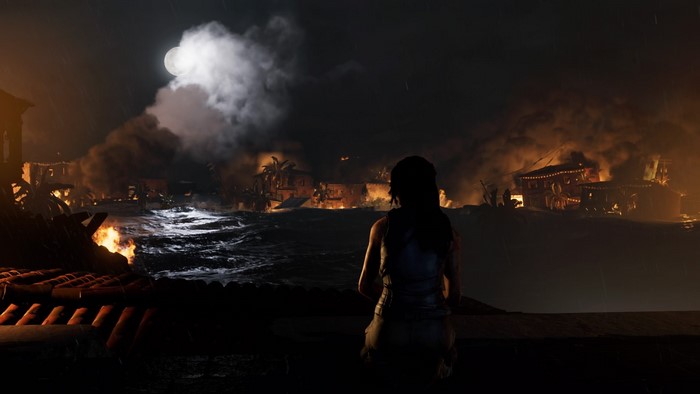 Lara Croft in Shadow of the Tomb Raider during a nighttime fire