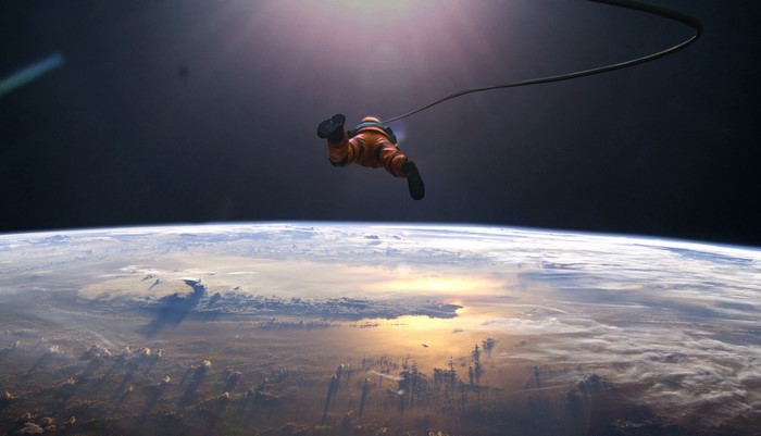 Astronaut floating in space above Earth