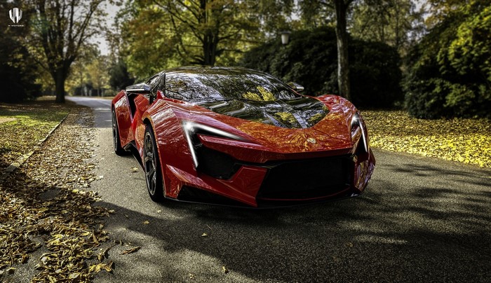 Red Fenyr Supersport car on a road with autumn leaves