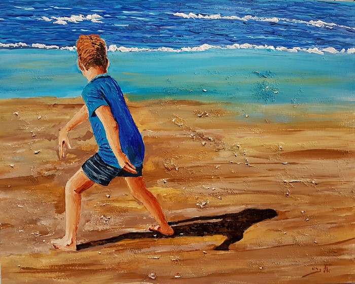 Boy playing on the seashore