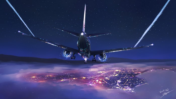 Airplane flying over city lights at night