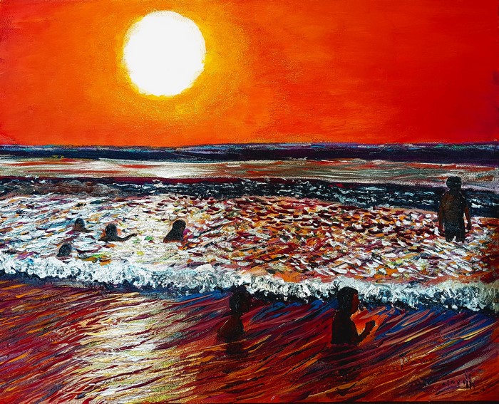 Children playing in the sea at sunset