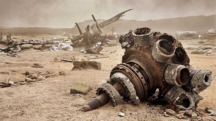 Airplane engine wreck on a sandy landscape