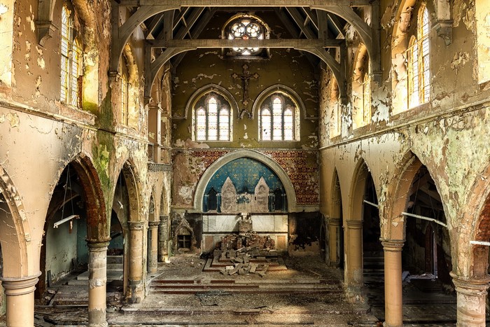 Interior of an abandoned church with peeling paint and debris