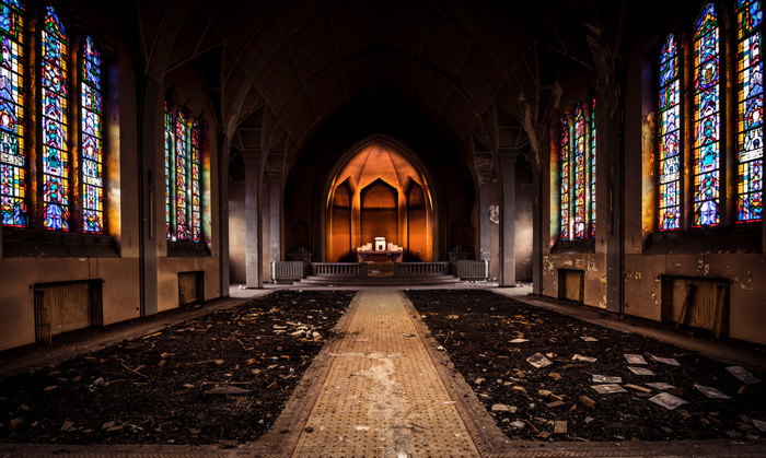 Abandoned church interior with stained glass and altar