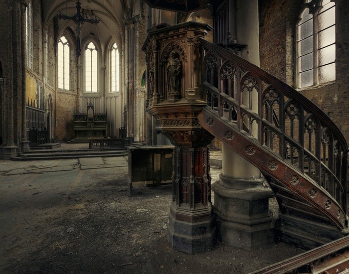 Abandoned church interior with wooden pulpit and stairs
