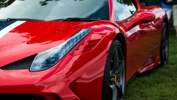 Red Ferrari 458 Speciale sports car with racing stripes