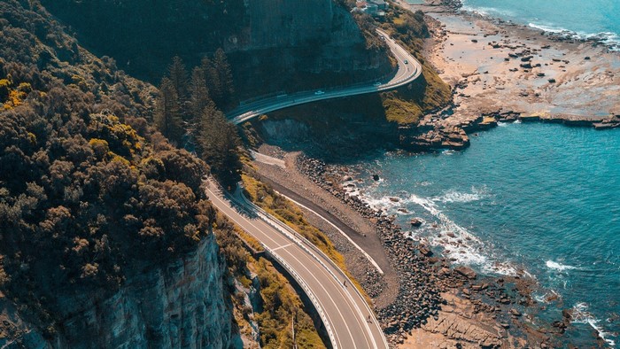Coastal road winding along a cliff by the ocean