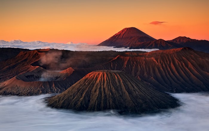 Mount Bromo volcano landscape at sunrise with clouds
