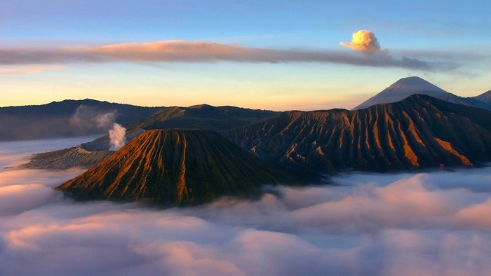 Mount Bromo volcano landscape with clouds at sunrise