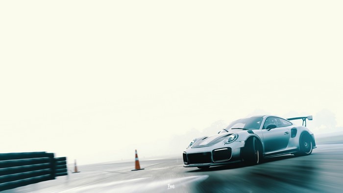 Silver Porsche 911 GT2 RS drifting on a track