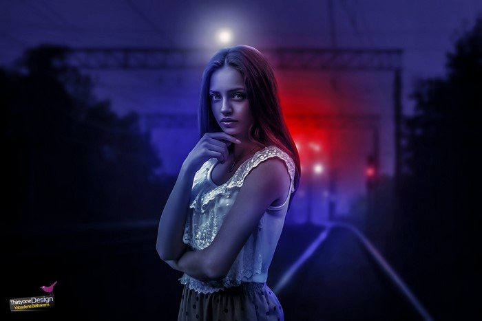 Woman posing at night with red and blue lights