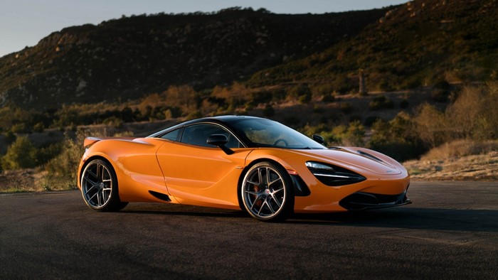 Orange McLaren 720S sports car on a road