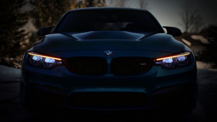 Frontal view of a BMW M car at dusk