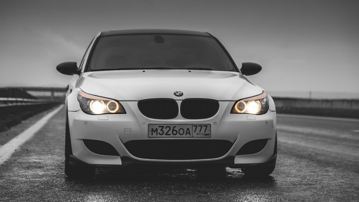 BMW 5 Series Front View on Rainy Road