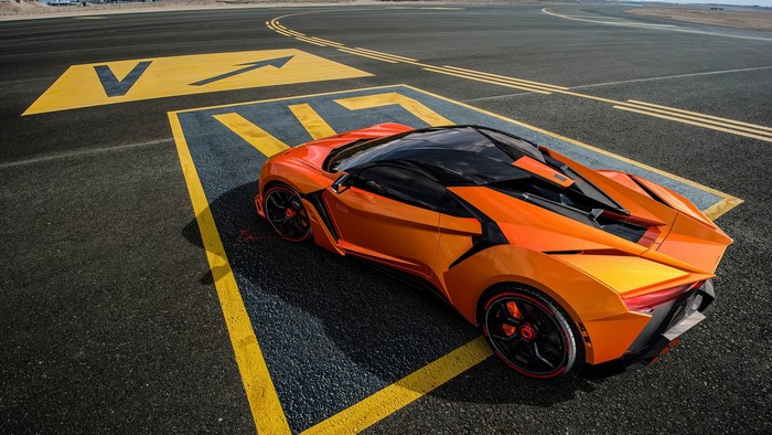 Orange Fenyr Supersport car on airport runway