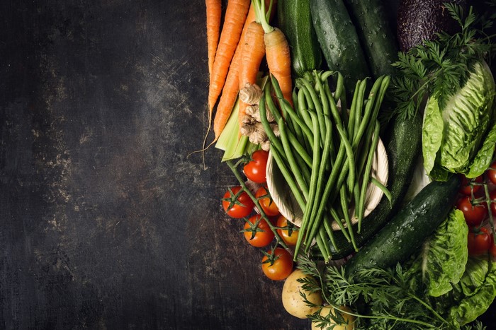 Assortment of fresh vegetables on a dark surface