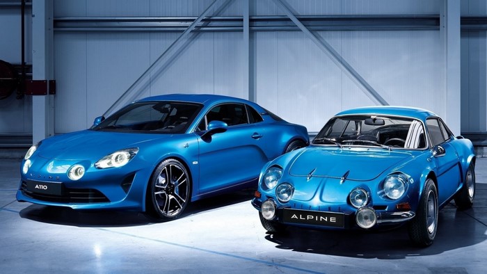 Two blue Renault Alpine cars, one modern and one classic