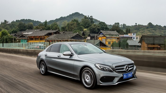 Silver Mercedes-Benz C-Class driving on a road