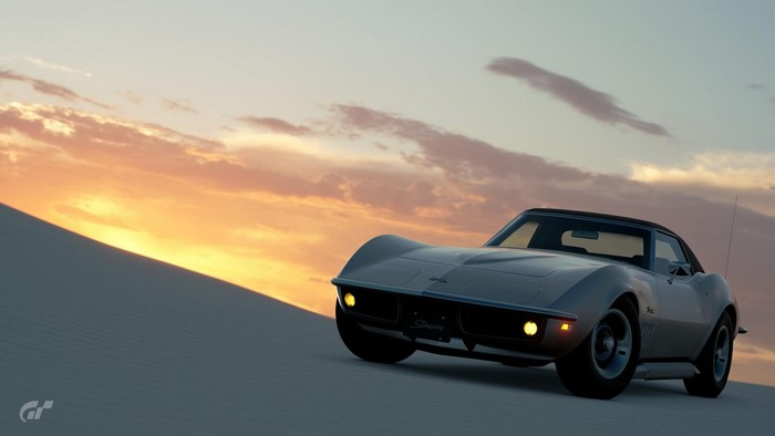 Silver Chevrolet Corvette Stingray in a desert at sunset