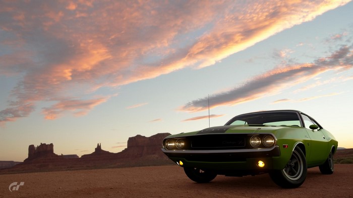 Green Dodge Challenger in Monument Valley at sunset