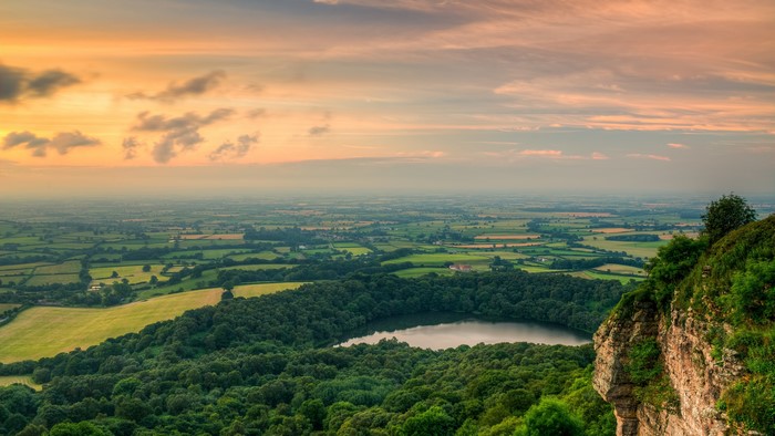 4K landscape with lake and forest at sunset