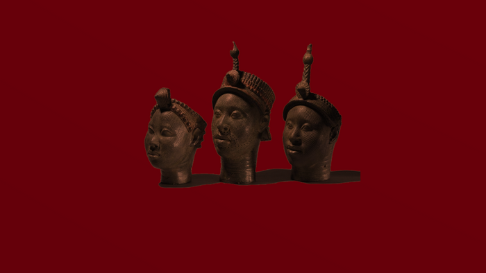 Three Benin Bronzes on a red background