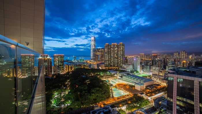 Night cityscape of Hong Kong with illuminated skyscrapers and a park