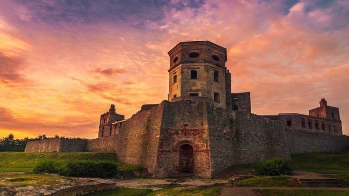 Ruined castle at sunrise with colorful sky