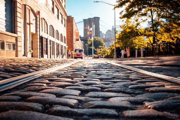 Cobblestone street with Brooklyn Bridge in New York City